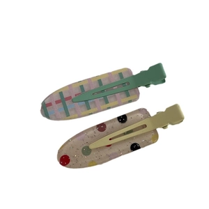 Set of two colorful rainbow and polka dot hair clips with glitter and green metal bases