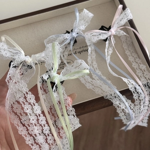 Close-up of pastel lace bow hair clips in multiple colors inside a jewelry box