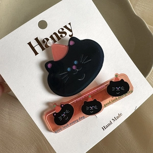 Dettaglio set di fermagli per capelli a forma di gatto nero in acrilico con cappello rosa