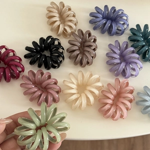 Elastici per capelli a spirale colorati in diverse tonalità pastello su sfondo bianco