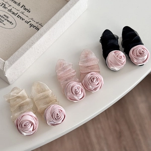 Detail of pink satin roses and pleated mesh on assorted hair clips in a romantic style