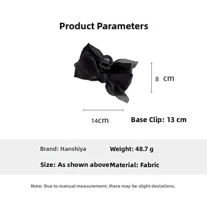 Detailed view of large black polka dot mesh bow hair claw clip with size measurements