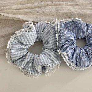 Two-pack striped scrunchies with white lace edges in light and dark blue tones