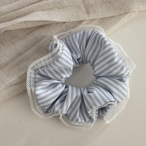 Detail of blue and white striped scrunchie with delicate white lace edging trim