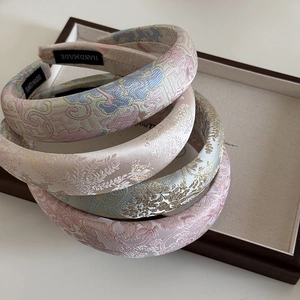 Close-up of handmade jacquard embroidery headbands with intricate Chinese floral patterns