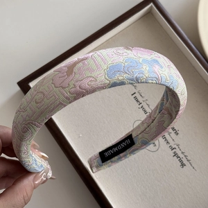Detailed close-up of handmade floral jacquard embroidery on a Chinese style headband