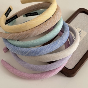 Set of six colorful padded fabric headbands with twill texture and handmade labels
