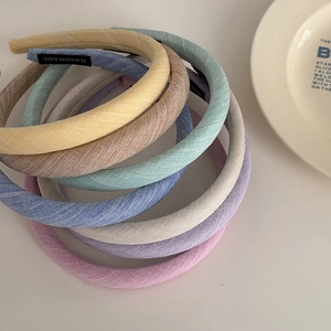 Flat lay of colorful handmade fabric sponge headbands in soft pastel macaron colors