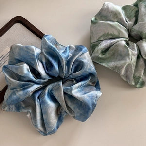 Detail of oil painting print satin scrunchies with elegant glossy silk texture