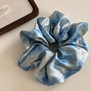 Detail of artistic oil painting pattern satin hair scrunchie with blue starry night swirls