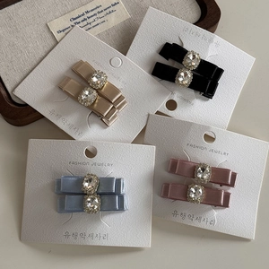 Lot de barrettes à cheveux en satin avec strass en coloris doré, noir, bleu et rose
