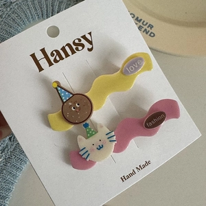 Detail of cute cartoon bunny and cat wave hair clips in yellow and pink resin