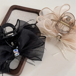 Elegant mesh bow hair clips with feathers and crystals in black and champagne