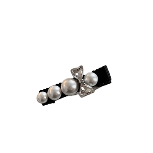 Elegant bow hair clip with rhinestones and faux pearls on a black ribbon duckbill clip