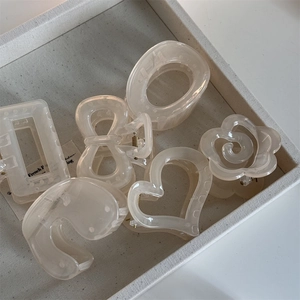Elegant cream camellia hair claw clips set in heart and floral resin shapes