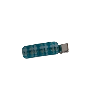 Blue and white checkered acetate hair clip with silver metal base on white background