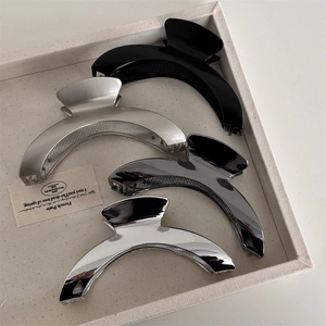 Minimalist large curved hair claws in matte and glossy metal finishes for women