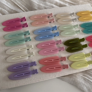 Detailed arrangement of colorful matte hair clips in diverse Morandi tones for styling