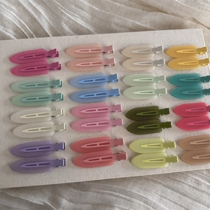 Flat lay of 32 pieces colorful matte resin hair clips in various macaron shades