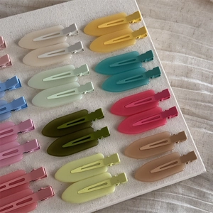 Flat lay of colorful matte duckbill hair clips in assorted macaron jelly tones
