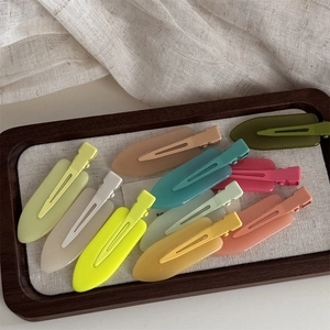 Matte macaron pastel hair clips set arranged in a wooden tray with fabric lining