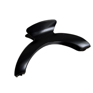 Matte black curved hair claw clip for women with a minimalist crescent design