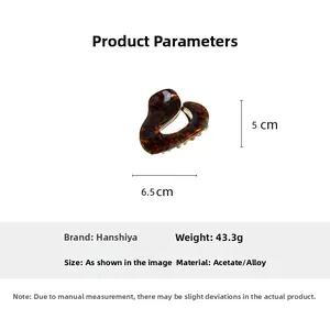 Detailed view of irregular tortoise acetate hair claw clip with size measurements 6.5x5cm