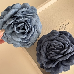 Oversized camellia rose hair claw clips in light and dark blue denim fabric texture