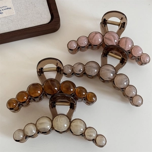 Elegant translucent large shark hair claw clips with marble bead accents for women