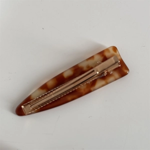 Tortoiseshell acetate hair clips with gold metal grips for elegant daily styling
