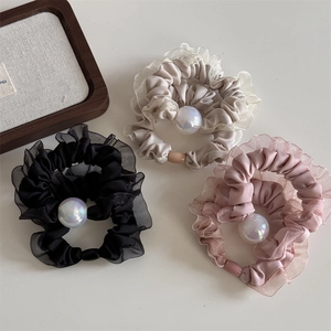 Three-pack mesh lace scrunchies in black, cream, and pink with iridescent pearl accent