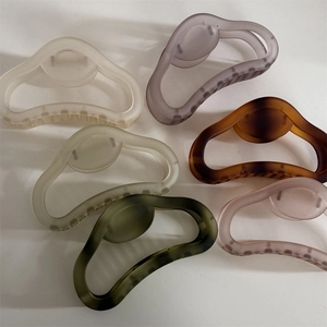 Detailed view of matte large hair claws in six colors with minimalist hollow design