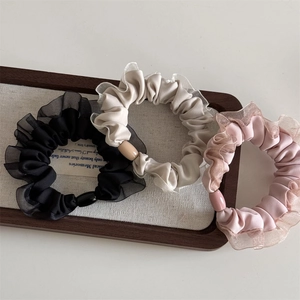Three-piece set of satin hair scrunchies with organza edges and pearls in neutral colors