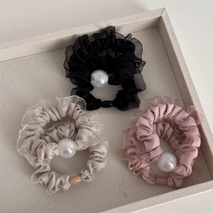 Three-piece set of mesh scrunchies with iridescent pearls in black, grey, and pink