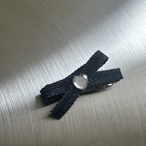 Close-up of Y2K black denim fabric hair claw clip featuring a heart-shaped rhinestone detail