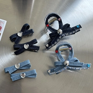 Y2K denim bow hair claw clips with heart rhinestones on a metal background