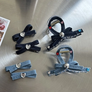Detailed macro view of y2k denim hair clips with sparkling heart-shaped rhinestones