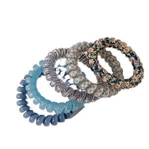 Set of 5 elastic spiral hair ties in blue, grey, checkered and floral patterns