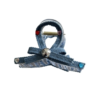 Y2K denim bow hair claw clip with heart-shaped rhinestones and silver bead on white backdrop