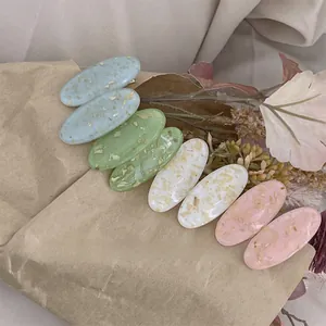 Détail de pinces à cheveux ovales avec feuilles d'or en couleurs pastel lot de 8