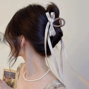 Elegant champagne satin bow hair claw with long ribbon and white pearl necklace