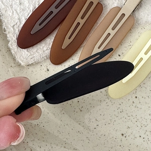 Minimalist matte hair clips in earthy tones shown with an opening mechanism action