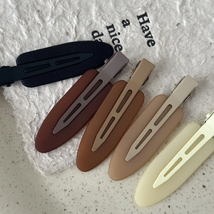 Set of five matte duckbill hair clips in earth tones including black, brown, and beige colors