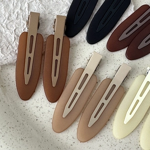 Matte finish duckbill hair clips in black, brown, and cream colors for daily styling