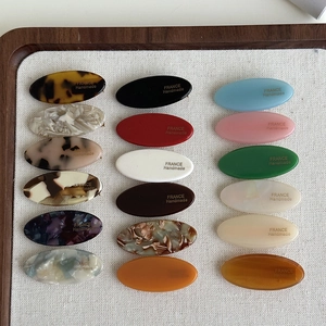 Oval acetate hair clips in multiple colors with France Handmade text on board
