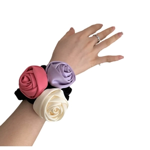 Three-color satin rose flower scrunchie set on wrist featuring pink and lilac silk petals