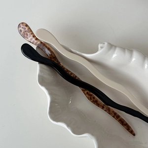 Minimalist S-shaped acetate hair sticks set in leopard, cream, and black colors