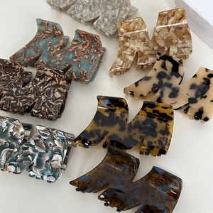 Detailaufnahme von M-förmigen Acetat-Haarklammern mit Marmor- und Schildpattmuster