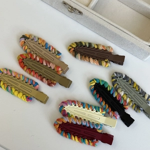 Eight-piece set of knitted edge hair clips in autumn colors on white background