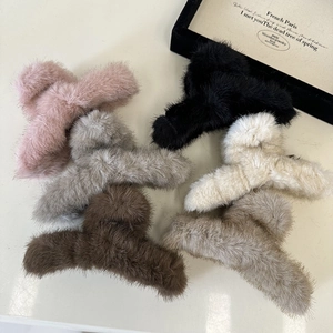 Detail of soft plush shark hair claws in six colors including pink, grey, and beige